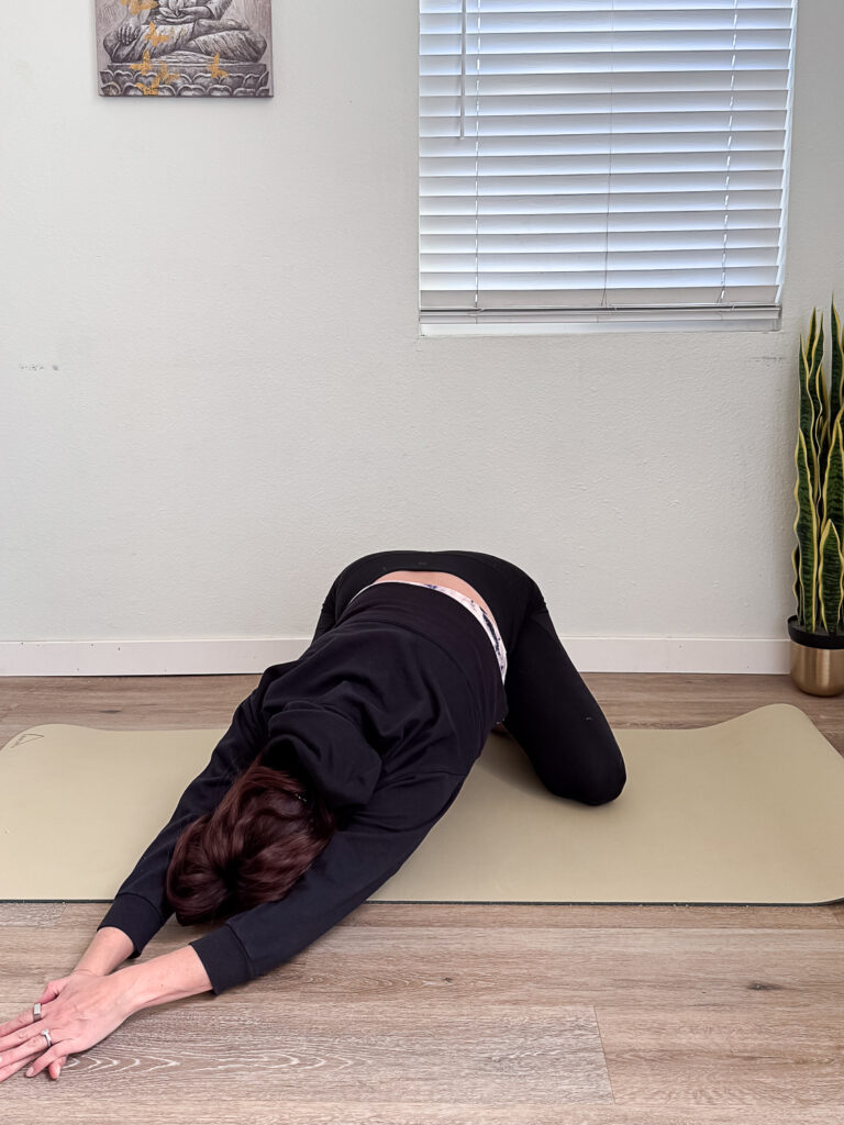 Pacific Yoga & Fitness, online yoga instructor, shares Yoga For Low Back Pain. childs pose with lateral flexion.
